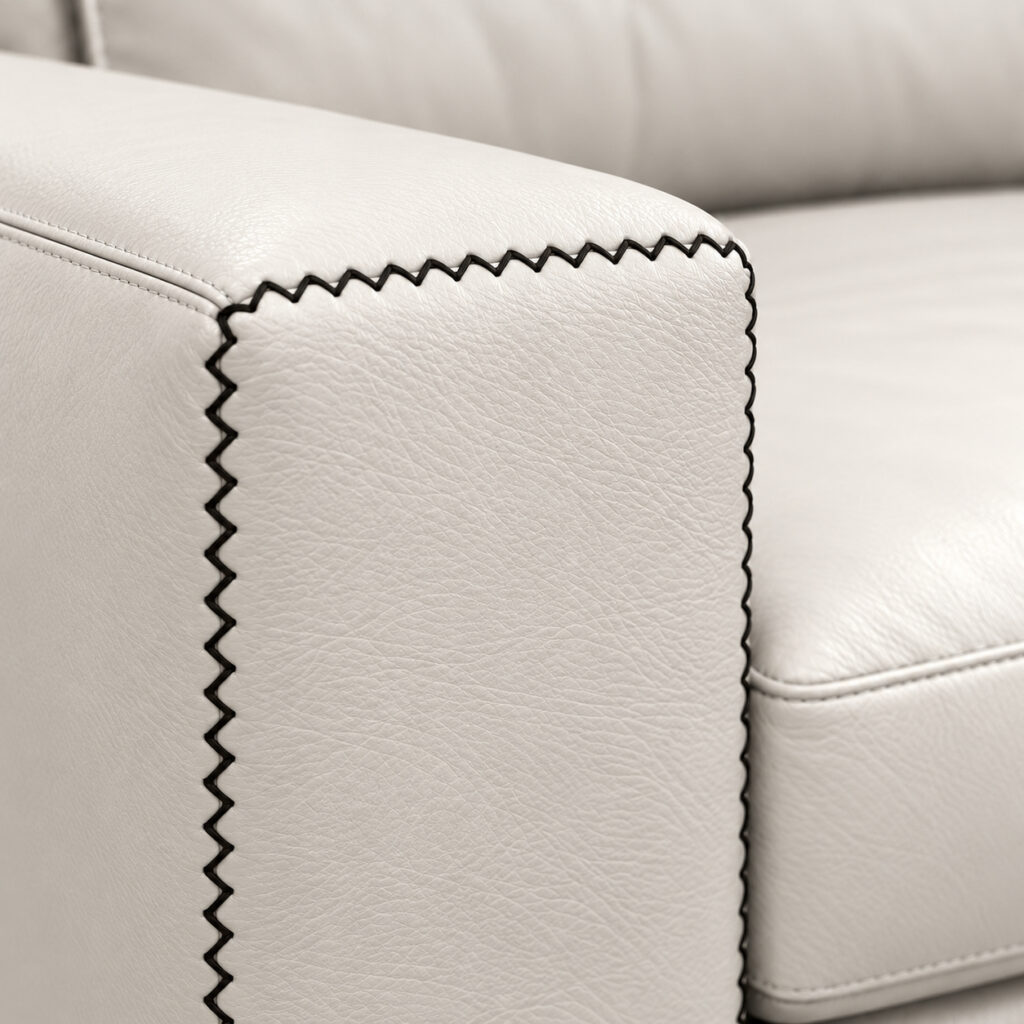 White leather upholstery with black decorative stitching on the Alfred Sofa